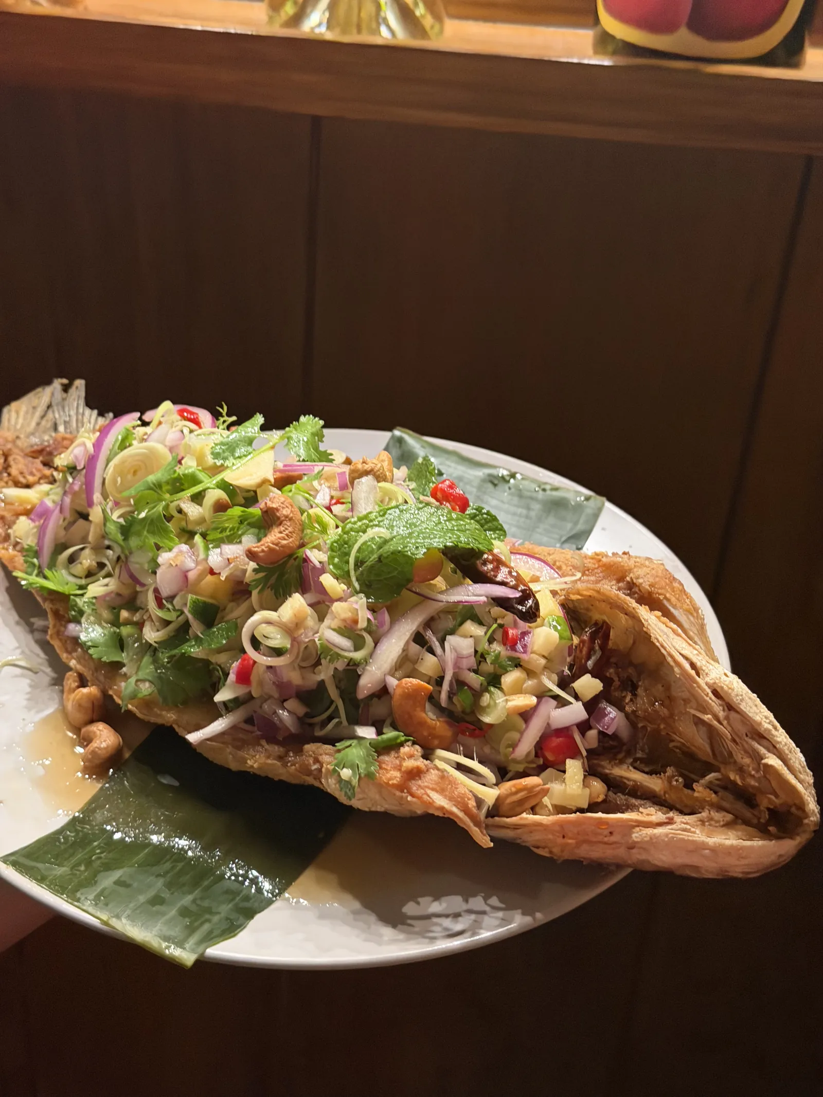 Crispy whole fish topped with a fresh Thai herb salad
