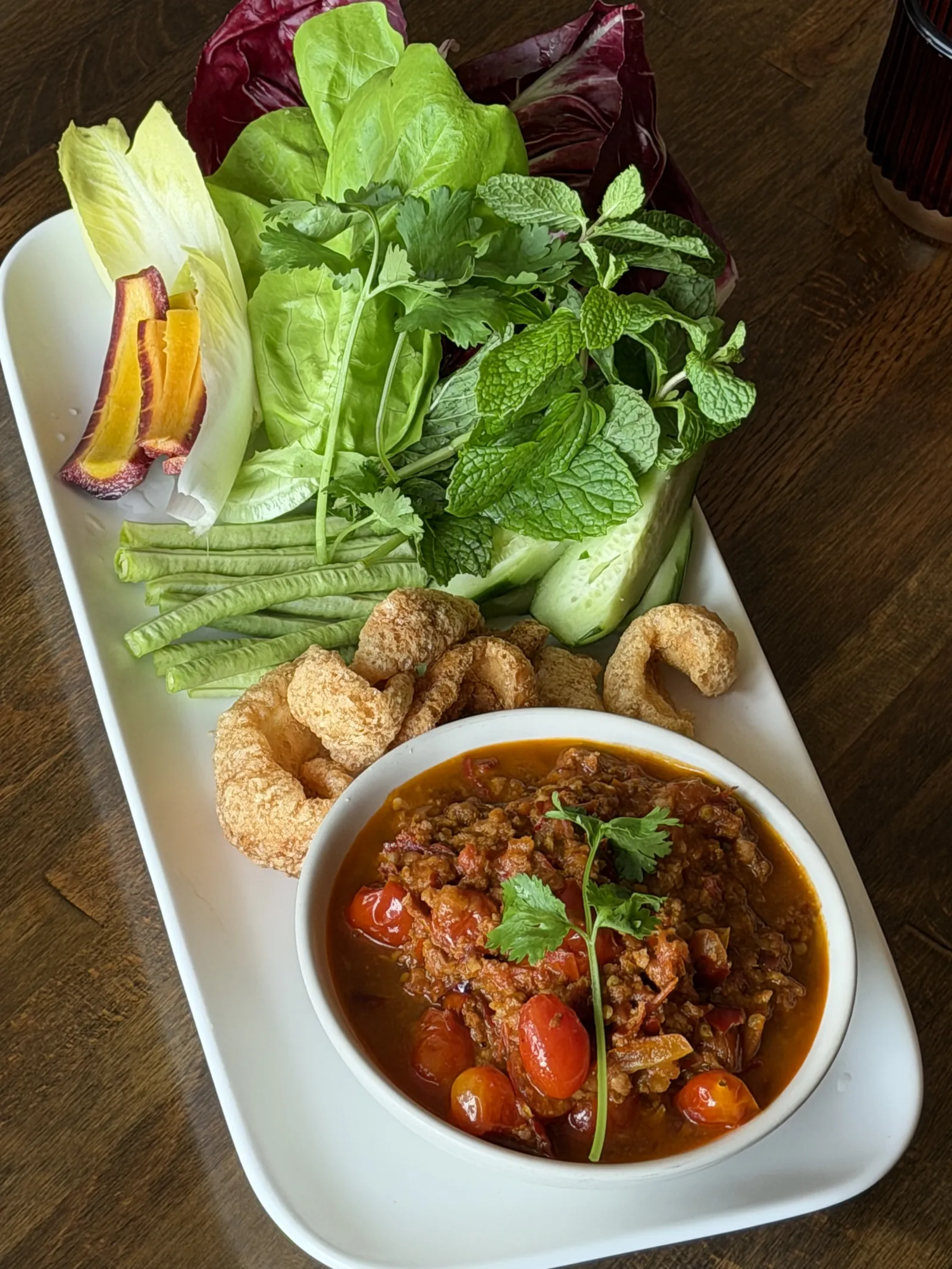 Northern Thai tomato and pork chili dip with fresh vegetables and pork cracklings