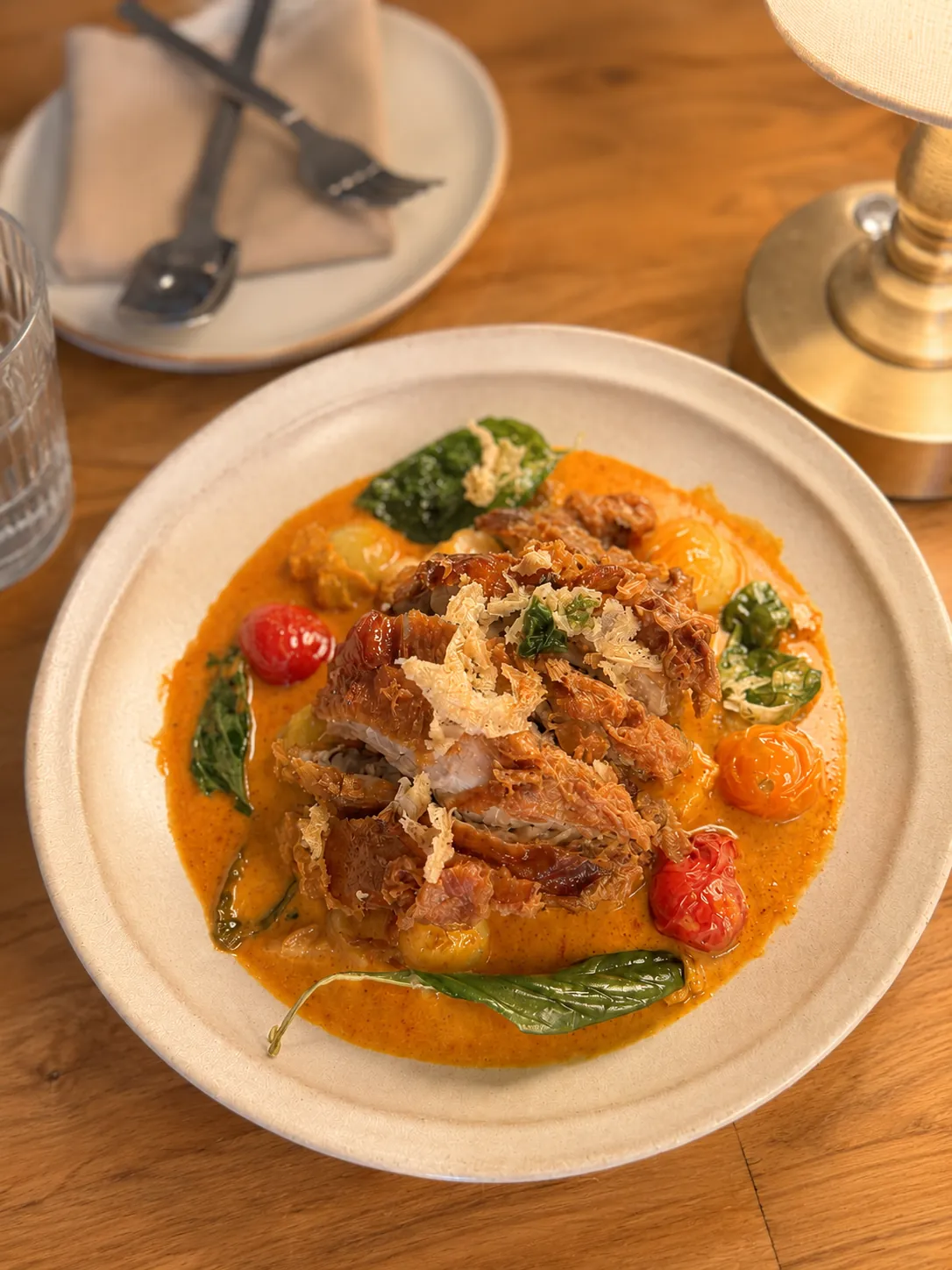 Red curry with crispy duck, cherry tomatoes and Thai basil